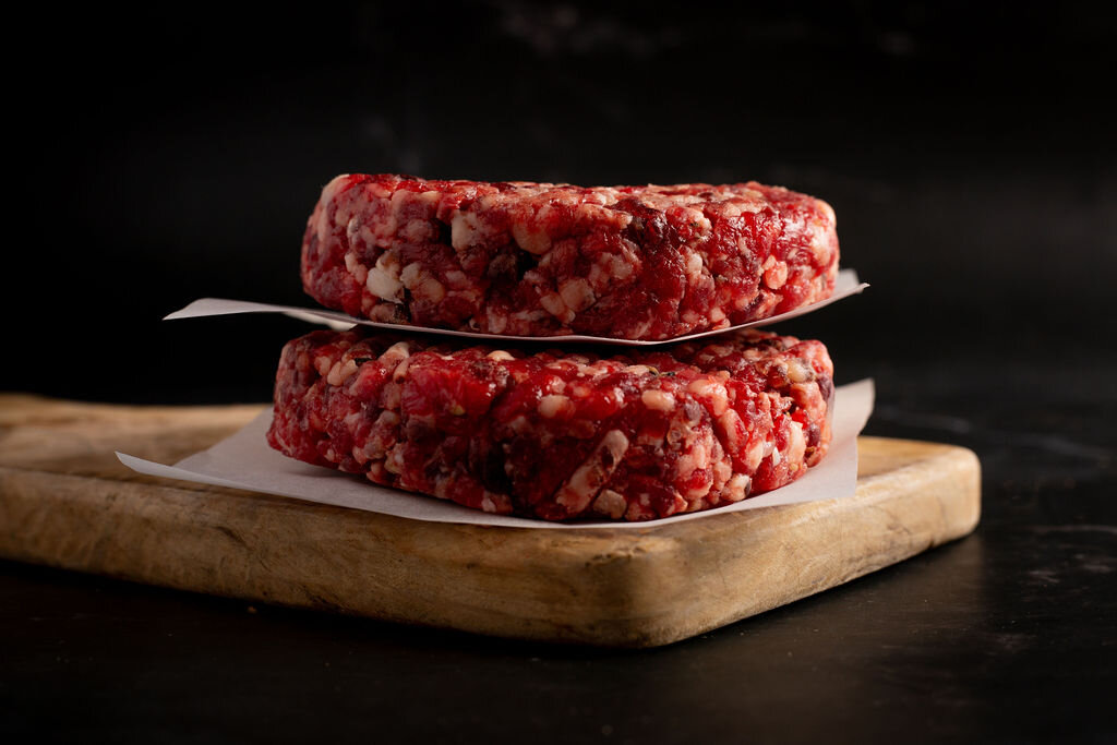 A Hugh Maguire butcher holding a whole cut of aged beef