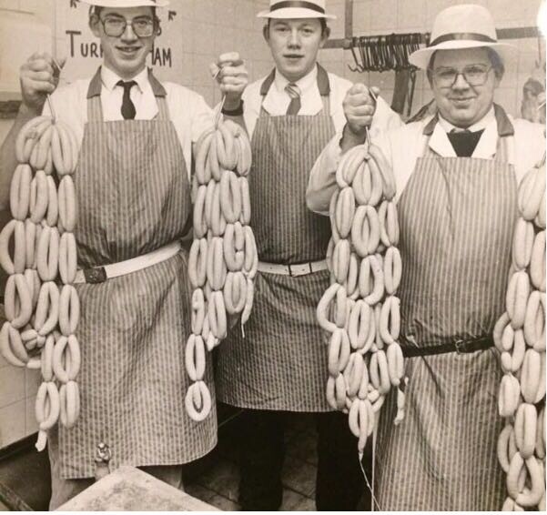 An early photograph of Hugh Maguire and Billy behind the butcher counter
