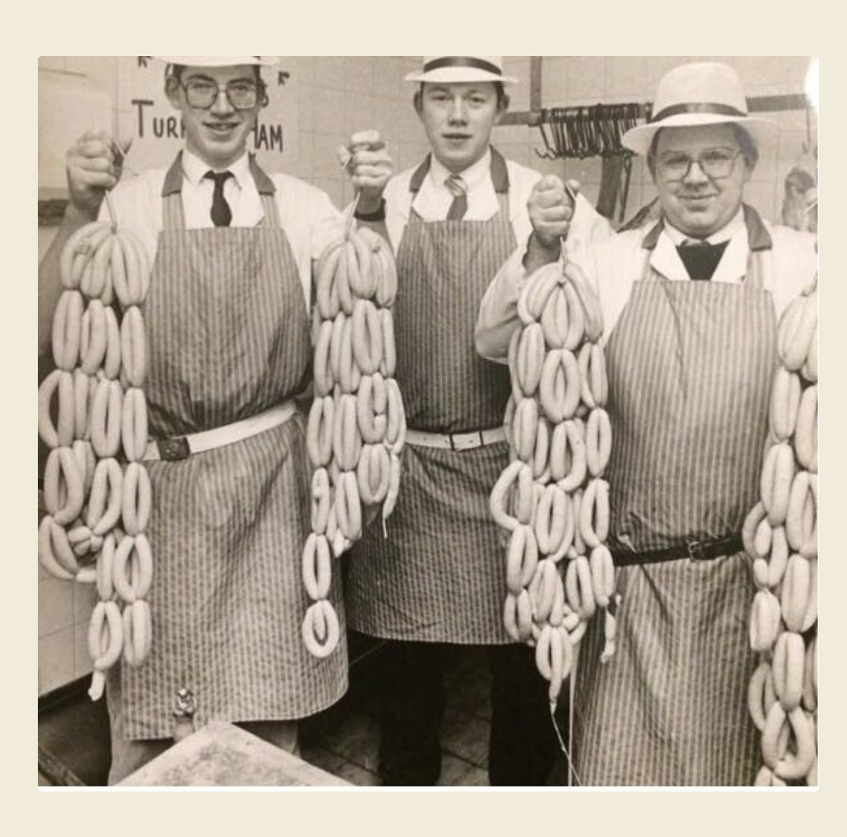 Early photograph of the Hugh Maguire butchers holding strings of sausages at the Trimgate Street shop